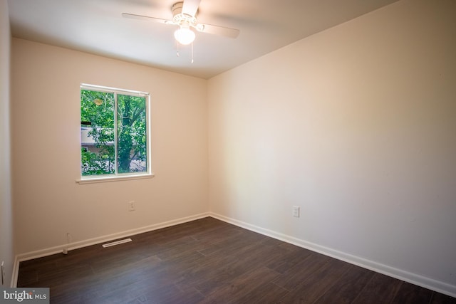 unfurnished room with dark hardwood / wood-style floors and ceiling fan