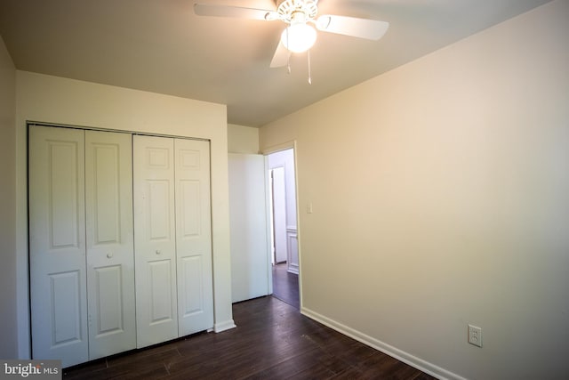 unfurnished bedroom featuring ceiling fan, dark wood-type flooring, and a closet