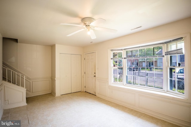 spare room with plenty of natural light and ceiling fan