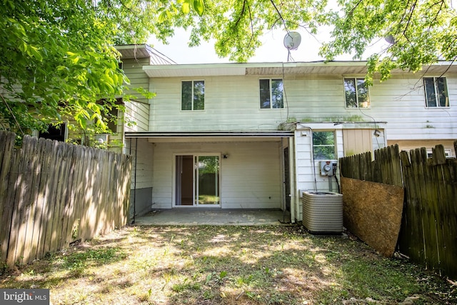 rear view of house with central AC and a patio area