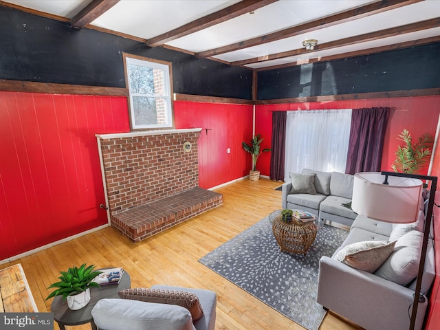 living room featuring beamed ceiling and wood-type flooring