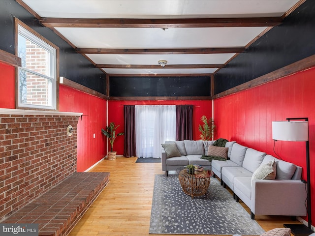 living room with beam ceiling and wood-type flooring