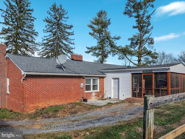 back of property featuring a sunroom