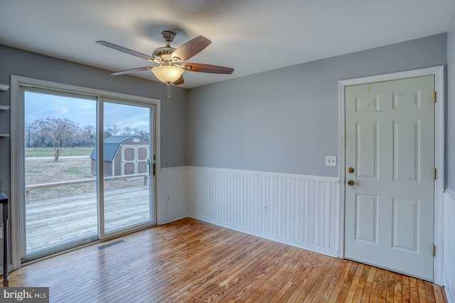 empty room featuring ceiling fan and light hardwood / wood-style floors