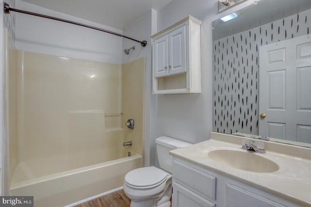 full bathroom featuring hardwood / wood-style flooring, vanity, bathtub / shower combination, and toilet