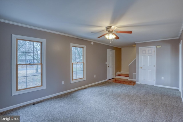 carpeted spare room featuring ceiling fan and ornamental molding