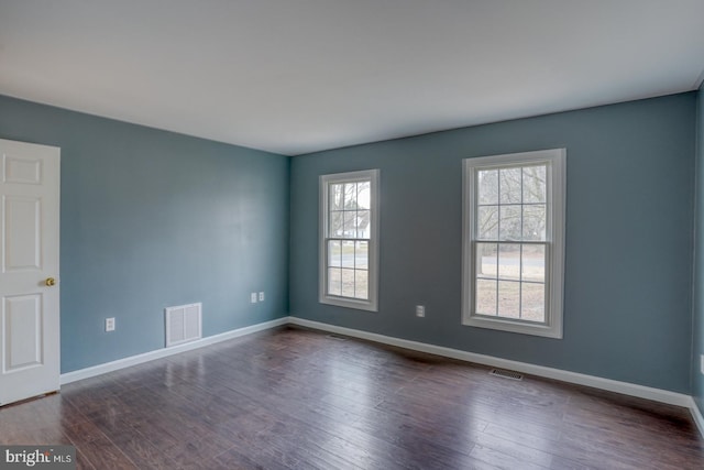 empty room with dark hardwood / wood-style floors