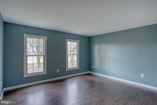 empty room featuring dark wood-type flooring