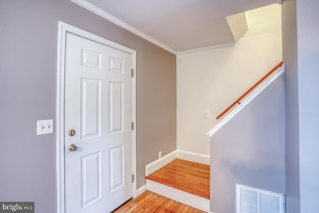 entrance foyer with light wood-type flooring and crown molding