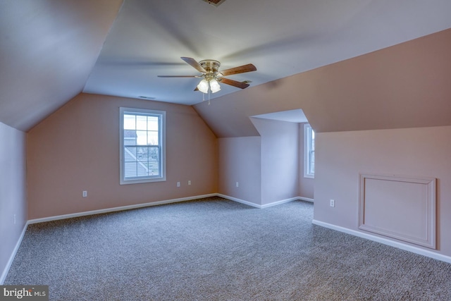 additional living space with ceiling fan, carpet, and vaulted ceiling