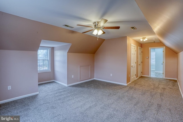 additional living space with ceiling fan, carpet, and lofted ceiling