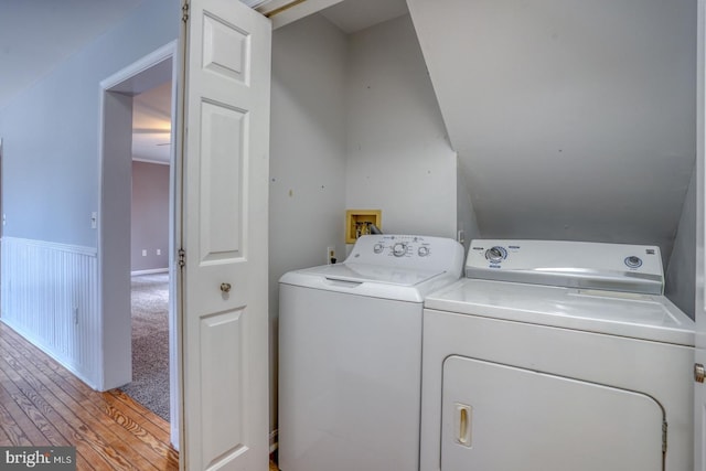 laundry room featuring separate washer and dryer and light colored carpet