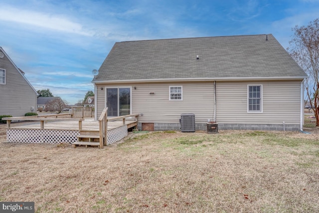 back of property featuring a lawn, central AC unit, and a deck