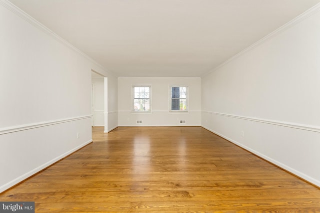 unfurnished room with light hardwood / wood-style floors and ornamental molding