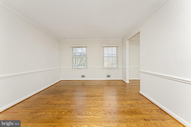 unfurnished room featuring wood-type flooring and crown molding