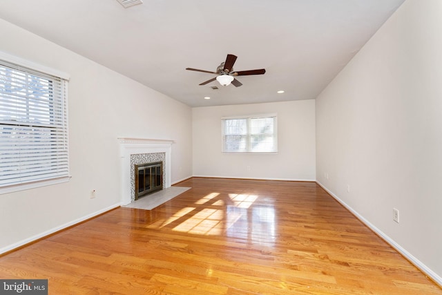 unfurnished living room featuring ceiling fan and light hardwood / wood-style flooring