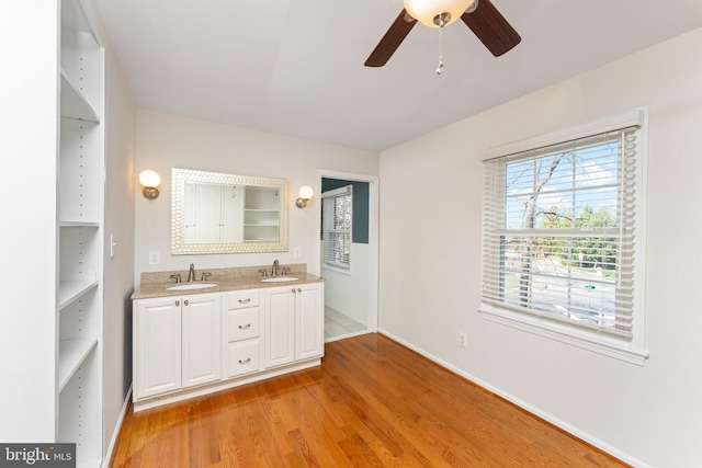 bathroom featuring ceiling fan, vanity, and hardwood / wood-style flooring