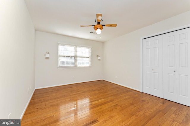 unfurnished bedroom featuring a closet, ceiling fan, and light hardwood / wood-style flooring