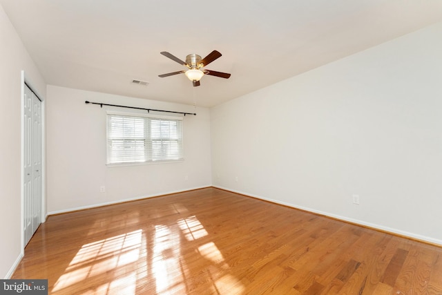 spare room featuring hardwood / wood-style floors and ceiling fan