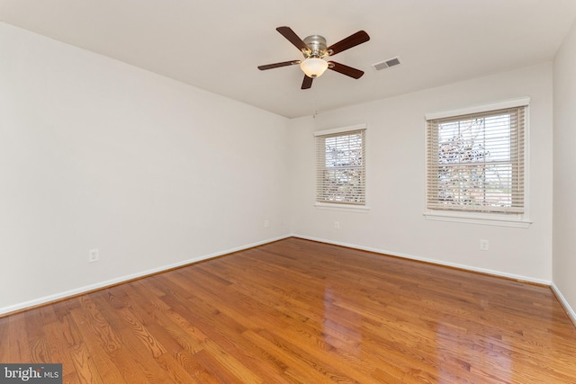 spare room with hardwood / wood-style floors and ceiling fan