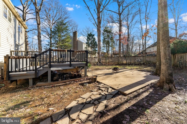 view of yard with a wooden deck and a patio