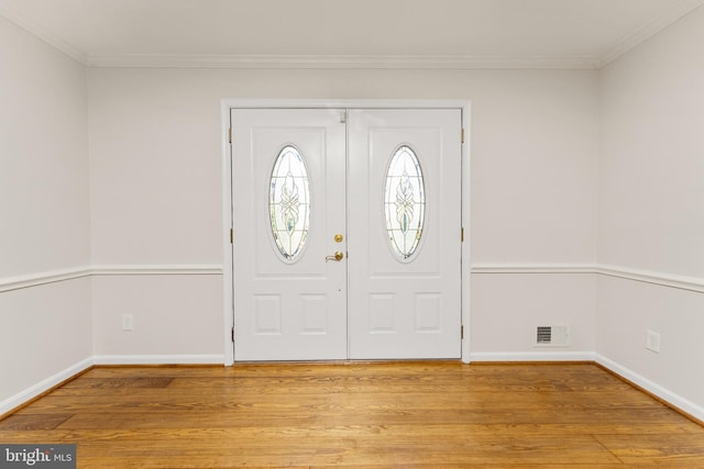 entryway featuring light hardwood / wood-style floors and crown molding