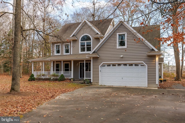 view of front of home with covered porch and a garage