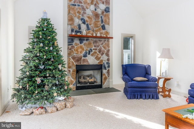 living room with a fireplace, carpet floors, and lofted ceiling