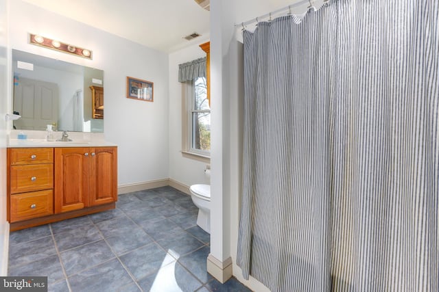 bathroom featuring tile patterned floors, vanity, and toilet