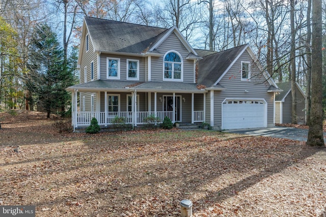 view of front of property with covered porch and a garage