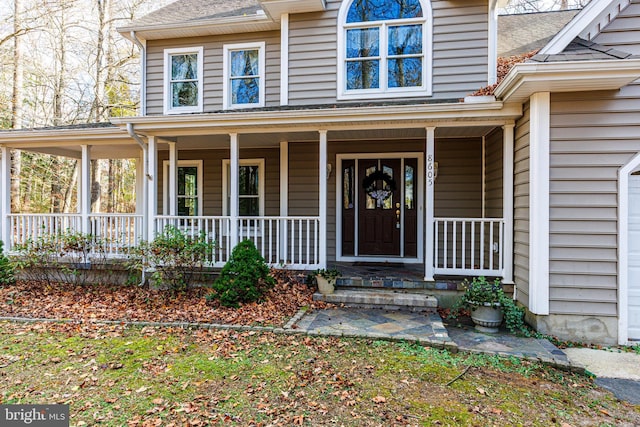 property entrance with covered porch