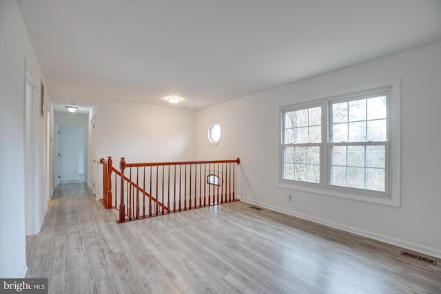 unfurnished room featuring light hardwood / wood-style floors