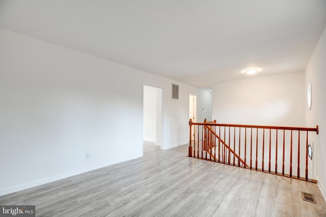 spare room featuring light hardwood / wood-style flooring