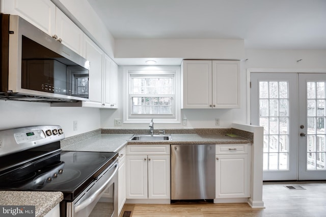 kitchen with french doors, sink, stainless steel appliances, and plenty of natural light