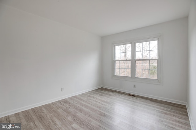 spare room with light hardwood / wood-style floors