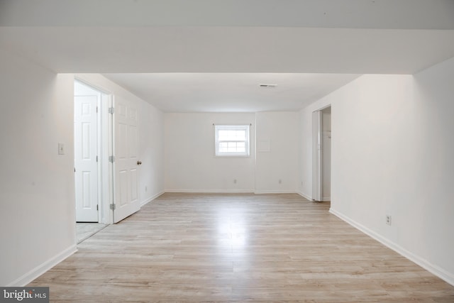 empty room with light hardwood / wood-style flooring