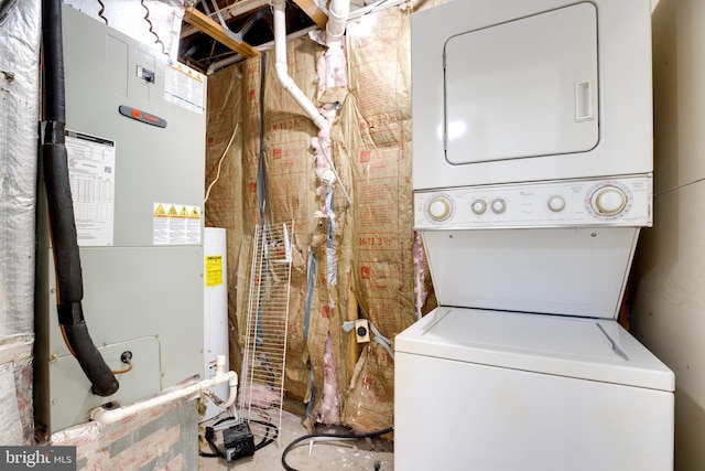 laundry room featuring heating unit and stacked washer and dryer