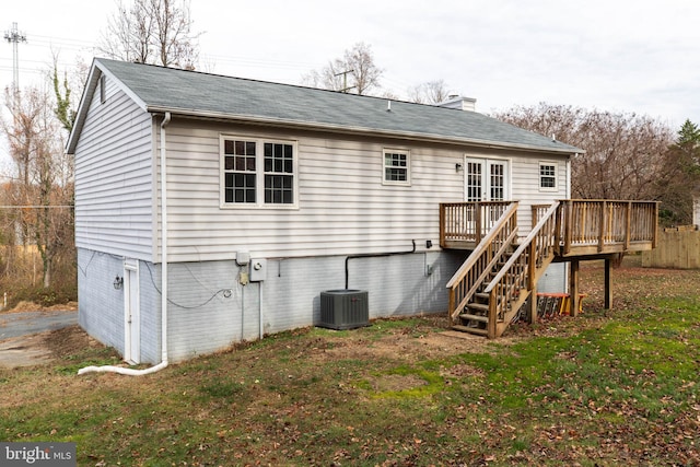 rear view of house featuring a yard, cooling unit, and a deck