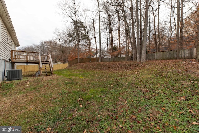 view of yard featuring central AC and a deck