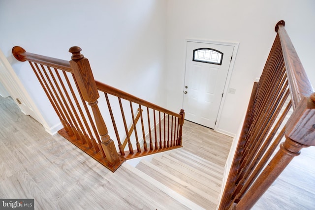 stairs with hardwood / wood-style floors