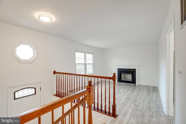 hallway with light hardwood / wood-style floors