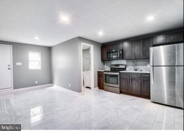 kitchen featuring dark brown cabinets and appliances with stainless steel finishes