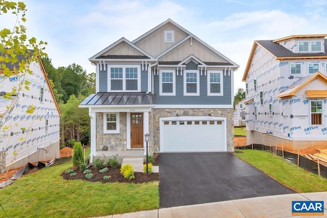 view of front of house with a front yard and a garage