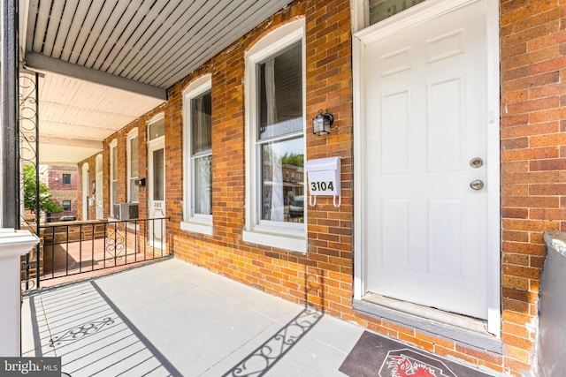 view of exterior entry with covered porch