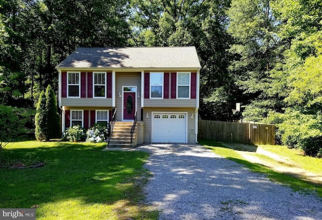 bi-level home with a garage and a front lawn