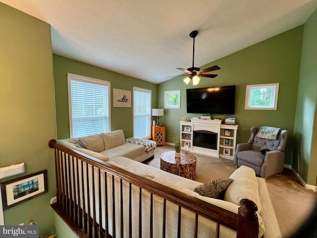 carpeted living room featuring ceiling fan, lofted ceiling, and a textured ceiling