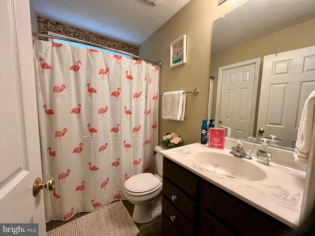 bathroom with tile patterned floors, a textured ceiling, toilet, vanity, and a shower with shower curtain