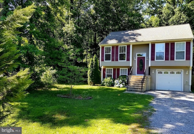 bi-level home with a garage and a front yard