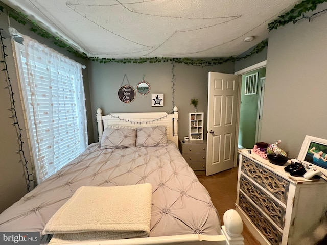 bedroom with a textured ceiling and carpet floors