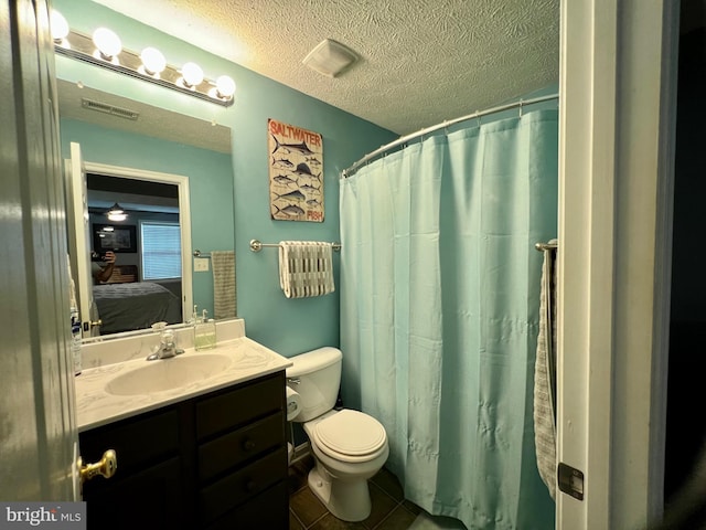 bathroom with tile patterned floors, a textured ceiling, toilet, vanity, and a shower with shower curtain